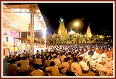 A giant evening satsang assembly on the mandir ground
