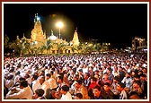 A giant evening satsang assembly on the mandir ground