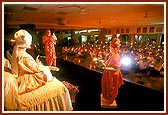 ... Swamishri and devotees perform arti in the assembly hall to commemorate the 199th arti anniversary