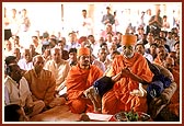 Swamishri, senior sadhus and devotees during the murti pratishtha rituals beneath the mandir dome