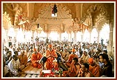 Swamishri, senior sadhus and devotees during the murti pratishtha rituals beneath the mandir dome