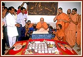 On Annakut Day, various sweet and other food items were sent in special thematic forms by various mandirs of India for Thakorji and Swamishri. Seen here are sweet items prepared by the earthquake affected people staying in the BAPS tin-tent city in Bhuj. The food items were arranged within a replica of the tin-tent city in Bhuj.
