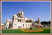 The consecrated Shri Swaminarayan Mandir with lush green lawns and flowers