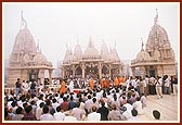 Swamishri during morning darshan with a foggy mandir backdrop