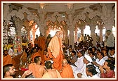 Swamishri showers rice grains to bless the devotees of Khandesh participating in the mahapuja ceremony