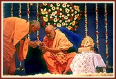 Senior sadhus bow and offer respects to Swamishri on his birthday