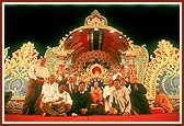 Senior devotees offer a garland to Swamishri and receive blessings 