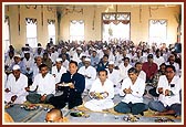 Devotees perform murti sthapna arti