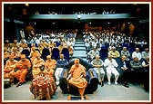 The 1st Annual Day assembly. Swamishri views a multimedia presentation