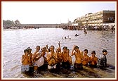 Devotees bathe and pray in the river Ghela