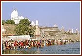 Devotees bathe and pray in the river Ghela