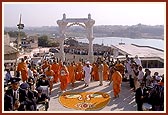 Swamishri is taken up the steps leading from the gateway to the shrines in the main mandir 