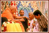 Swamishri blesses a balak after his janoi ceremony