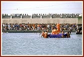 Swamishri bathes Shri Harikrishna Maharaj with the holy waters of river Ghela
