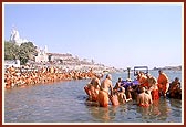 Swamishri sprinkles the holy river water on the senior sadhus