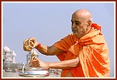 Swamishri bathes Shri Harikrishna Maharaj with the holy waters of river Ghela