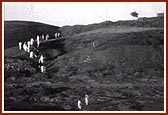 Devotees climb up the hillock near the river Ghela