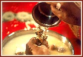 Swamishri performs panchamrut snan of Shri Harikrishna Maharaj during a mahapuja ceremony