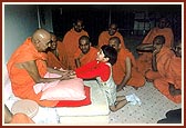 Swamishri blesses and converses with a local balak