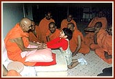 Swamishri blesses and converses with a local balak