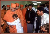Swamishri affectionately blesses two satsangi balaks who then embrace Swamishri with love