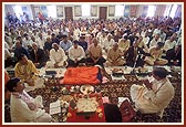 Shri Dr. K.C. Patel, Chairman of USA and Australia Satsang Mandals, addresses the devotees seated in the murti pratishtha ceremony