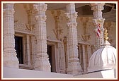 Intricately carved pillars and windows adorn the mandir exterior