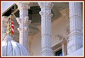 Intricately carved pillars and windows adorn the mandir exterior