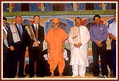 Swamishri with the government Ministers and dignitaries after the mandir opening ceremony assembly concluded at the Swaminarayan Mandir in Auckland