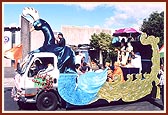 …sadhus singing devotional songs on the decorative peacock float with the murtis of Bhagwan Swaminarayan and Aksharbrahma Gunatitanand Swami