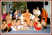 Swamishri with the 12 children who were given the yagnopavit