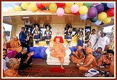 Swamishri seated on the upper deck with the new murtis of Shri Akshar Purushottam Maharaj and Shri Radha Krishna Dev behind