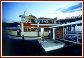 Swamishri disembarks from the boat after the 3-hour jal yatra