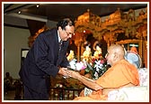 Mr. Stepan Kerkyasharian, Chairman of Community Relations Commission and representative of the Premier of New South Wales is blessed by Swamishri