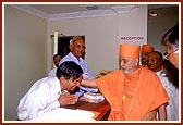 Swamishri blesses the devotees at the reception counter