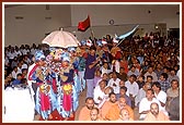 The procession with Thakorji advances towards the main stage of the mandir hall