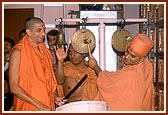 Sadhus play the drum, bell and jhalar during arti
