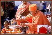 Swamishri bathes Shri Harikrishna Maharaj with water