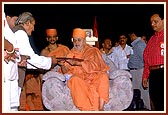 Members of the 'Shri Satyam Shivam Sunderam Trust' present a plaque to declare the opening of Shri Sarveshwar Mahadev for the public