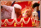 Swamishri blesses a devotee and his family members for donating land for a mandir building project