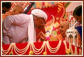 Swamishri blesses a devotee and his family members for donating land for a mandir building project