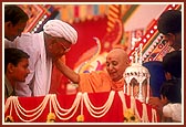 Swamishri blesses a devotee and his family members for donating land for a mandir building project