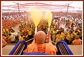 The devotees are blessed with a shower of holy colored water 