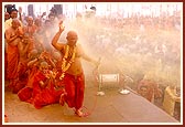 ... and while he dances he is drenched by a shower of colored water directed by Swamishri