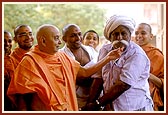 Swamishri blesses the village chief, Shri Raghabhai Bharwad