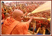 ... and also drenches the devotees with the holy water