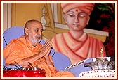 Out of reverance and devotion, Swamishri ritually bathes Shri Harikrishna Maharaj with panchamrut and water