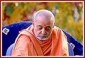 Swamishri places the articles of puja in the nidhi kumbh (auspicious pot)