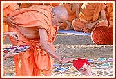 Swamishri gives the nidhi kumbh to be placed in the foundation-pit 