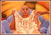 Swamishri is honored with a shawl of fragrant flowers